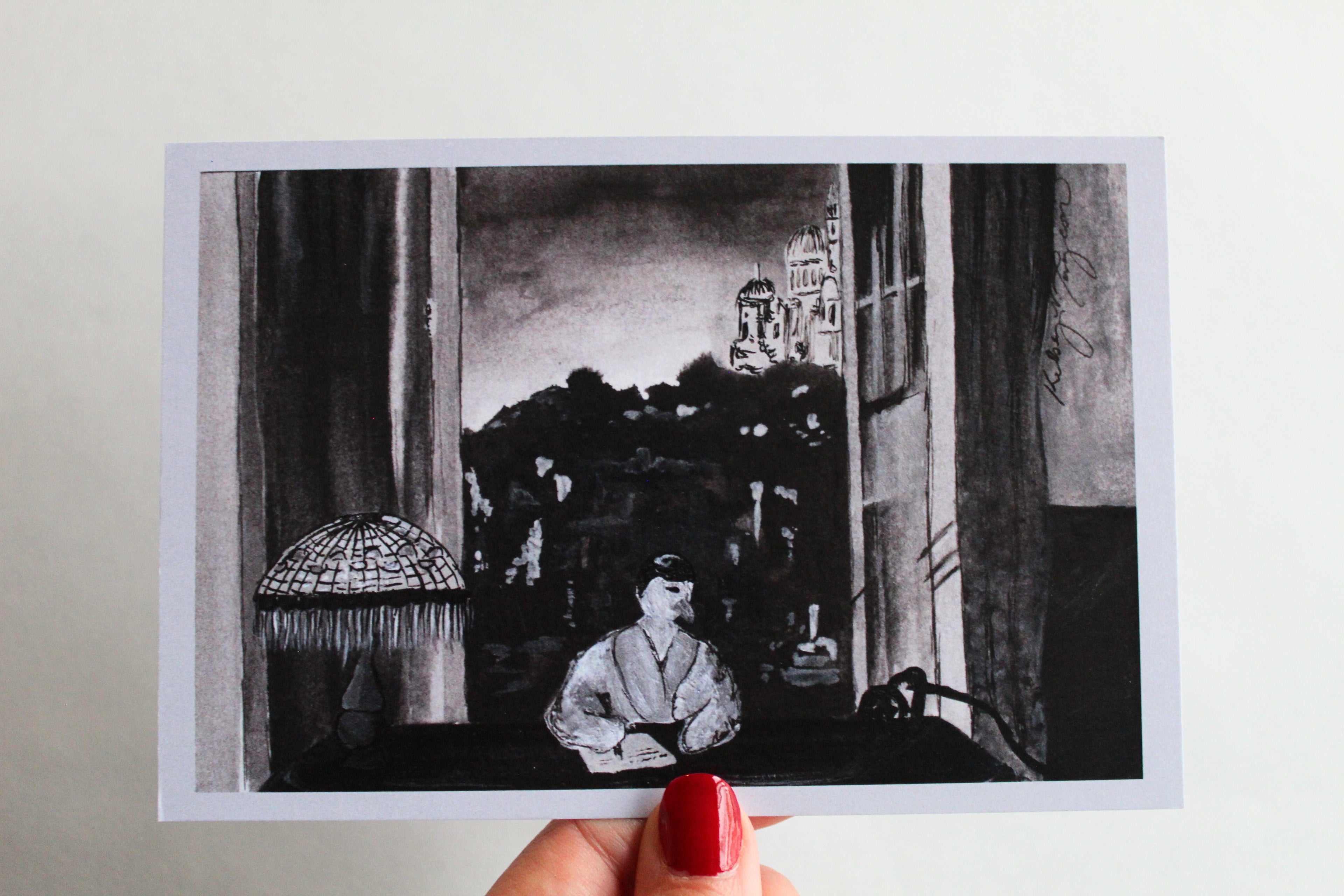 Postcard with an illustration of a duck sitting at a desk with an open window, wearing a robe as she writes a letter, with a Tiffany inspired lamp on the. 