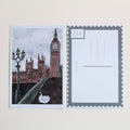 Postcard with an illustration of a duck in London, wearing a blue scarf and brown hat, walking on a bridge in front of Big Ben and Parliament. Pictured with the back of the postcard where a letter can be written and address lines. 